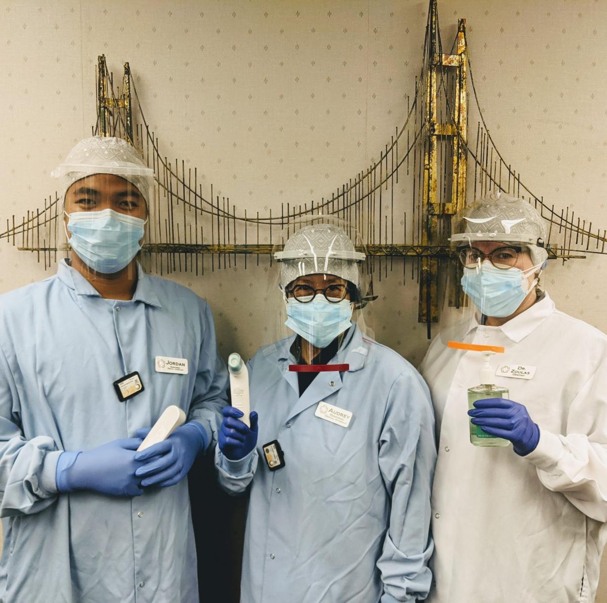 The team in holiday spirit — masked up and smiling